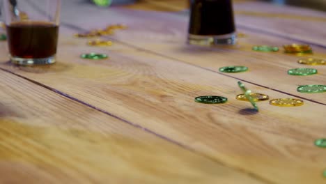 Close-Up-Of-Friends-At-Home-Or-In-Bar-Celebrating-At-St-Patrick's-Day-Party-Drinking-Alcohol-And-Spinning-Novelty-Gold-Coins-1