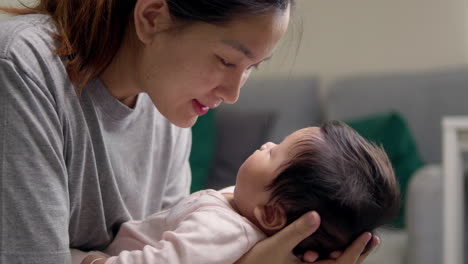 a caring mother soothing her baby girl to sleep with gentle words and loving eye contact at home, demonstrating dedication and affection in a nurturing environment