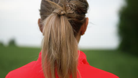 young blond female athlete recovering from an outdoor run by breathing deeply