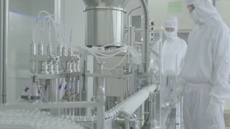 pharmaceutical manufacturing facility in sterile conditions, a skilled workforce of scientists and technicians collaborates to oversee and maintain the automated production lines factory