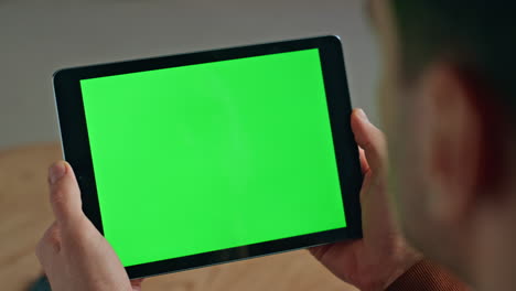 employee hands using chromakey tablet in office closeup. man looking screen