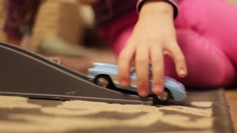 child kid playing with a toy car