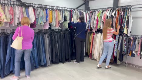 a group of people in second hand used clothing sale a group of people in second hand used clothing sale