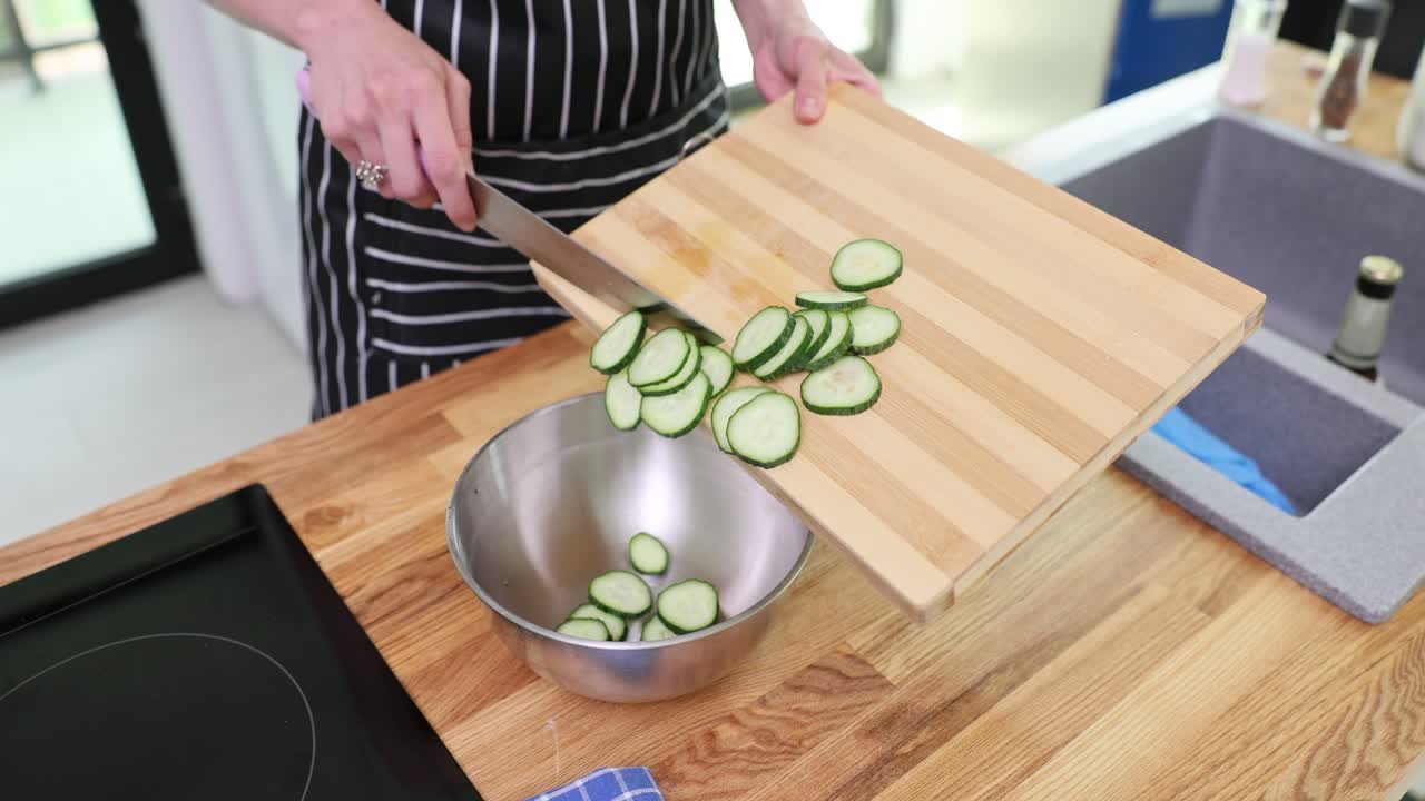 Slicing cucumbers in the kitchen