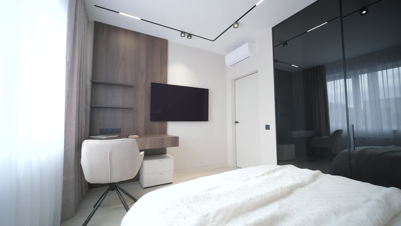 Stylish Modern Bedroom with Desk, TV, and Mirrored Closet