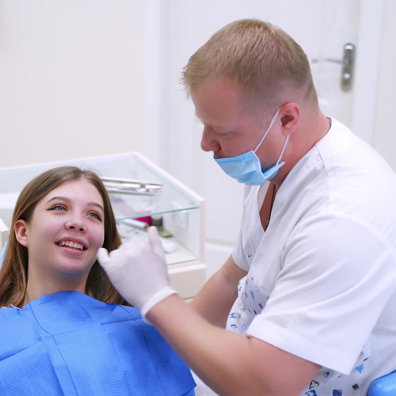 Dentist making examination of girl teeth