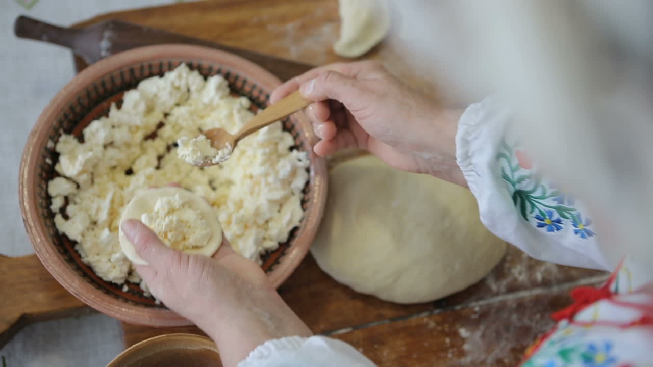 Cook making dumplings. Making of cheese dumplings from stuffing and dough