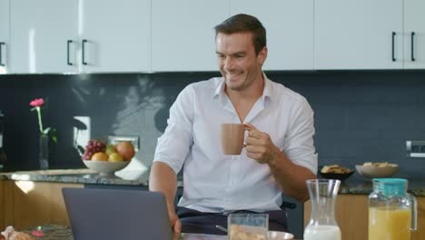 Happy-business-man-watching-video-in-big-kitchen.-Person-getting-shocked-news.