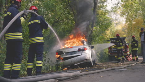 Firefighters Extinguishing a Car Fire
