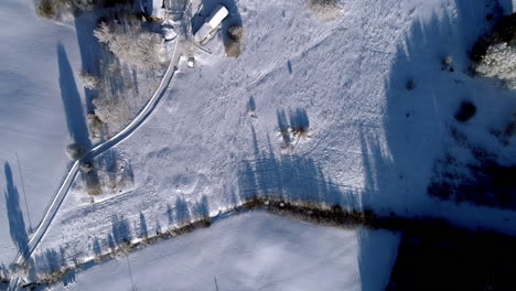 Volando-Sobre-Campos-De-Cultivo-Cubiertos-De-Nieve---Directamente-Hacia-Abajo-A-Vista-De-Pájaro-De-Un-Paisaje-Invernal