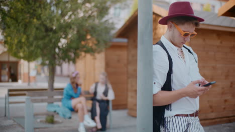 young man on smartphone in a city square