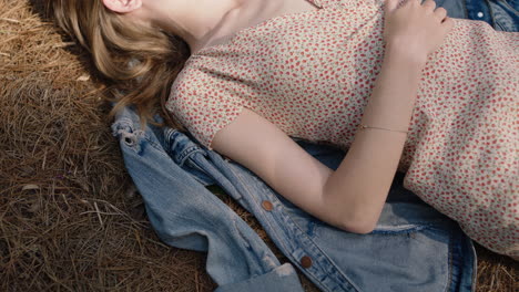 nature-girl-lying-on-ground-in-forest-daydreaming-relaxing-in-woods