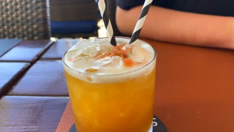 delicious summer fruity cocktail in a restaurant, cold refreshing drink, 4k shot