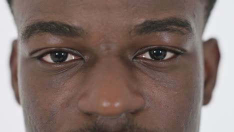 close up of blinking eyes of african businessman