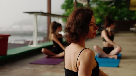 diverse girls on terrace with trainer doing stretching, close up