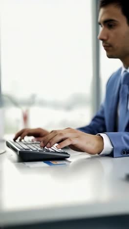 hands typing efficiently on keyboard in well-lit office