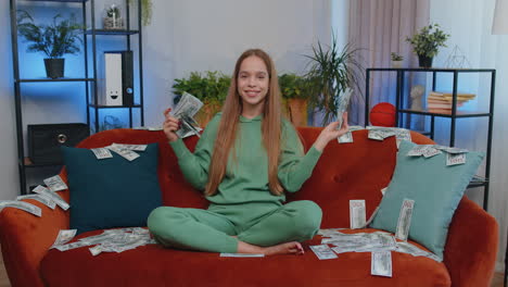 successful happy rich business woman counting money cheering up with high profits, lottery game win