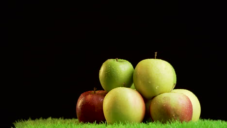 pile of shiny,vibrant apples on green rotating surface