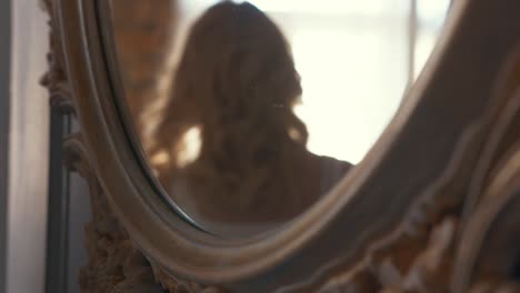 woman reflected in antique mirror