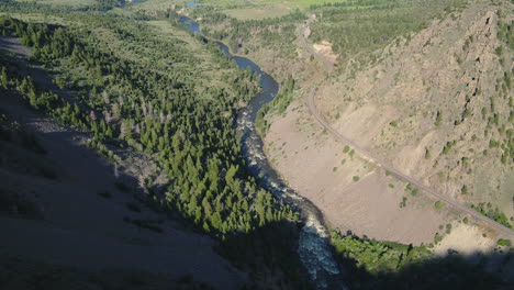 aerial drone of river running through forest in colorado rocky mountains