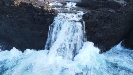 close drone footage of the bøsdalafossur waterfall near the leitisvatn lake, aka the floating lake, on the vagar island in the faroe islands