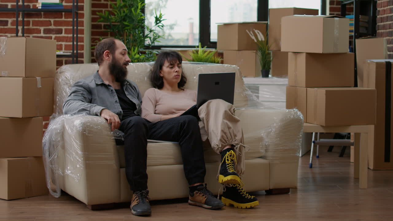 Young couple looking at interior decor on laptop website