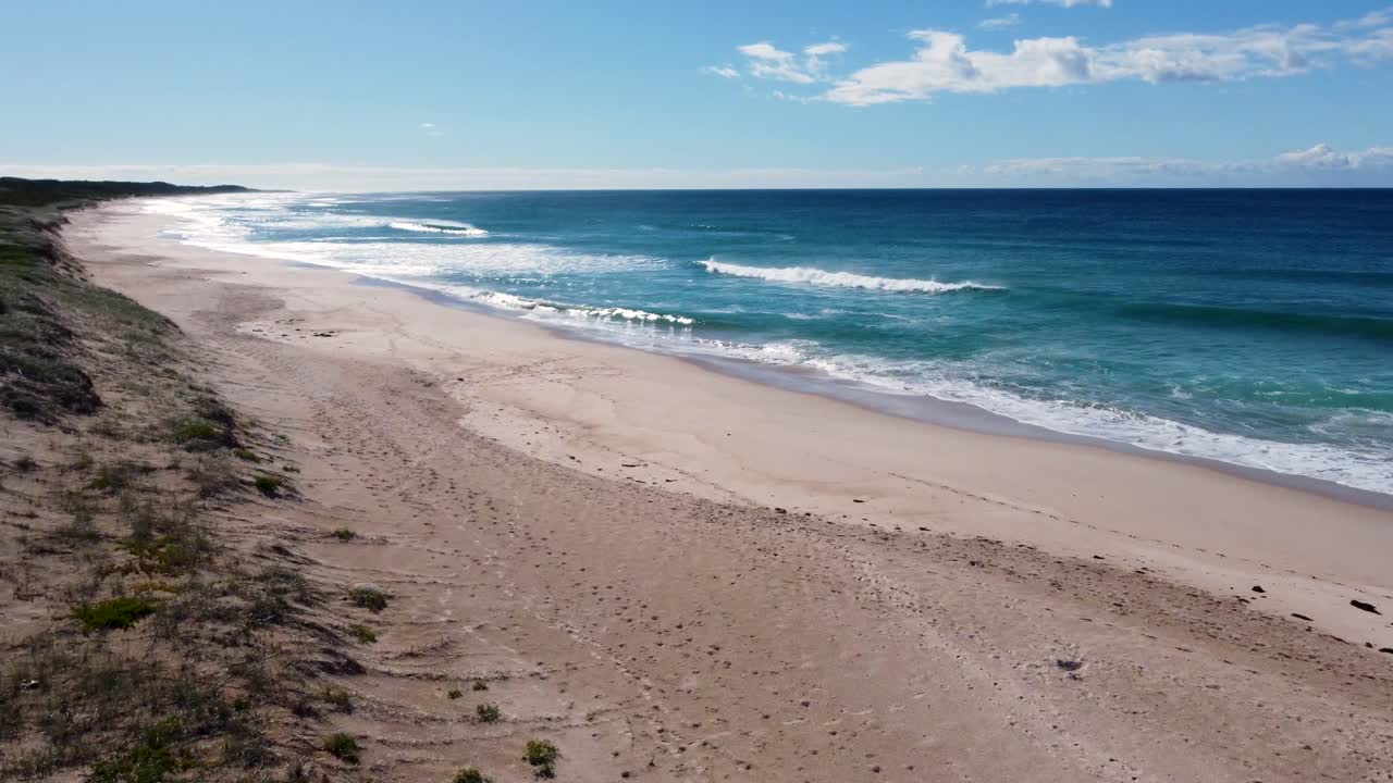 drones aéreos disparados desde la entrada magenta de la arena del océano pacífico regeneración de arrecifes dunas de arena cielo viajes turismo surf playa costa central nsw australia 4k