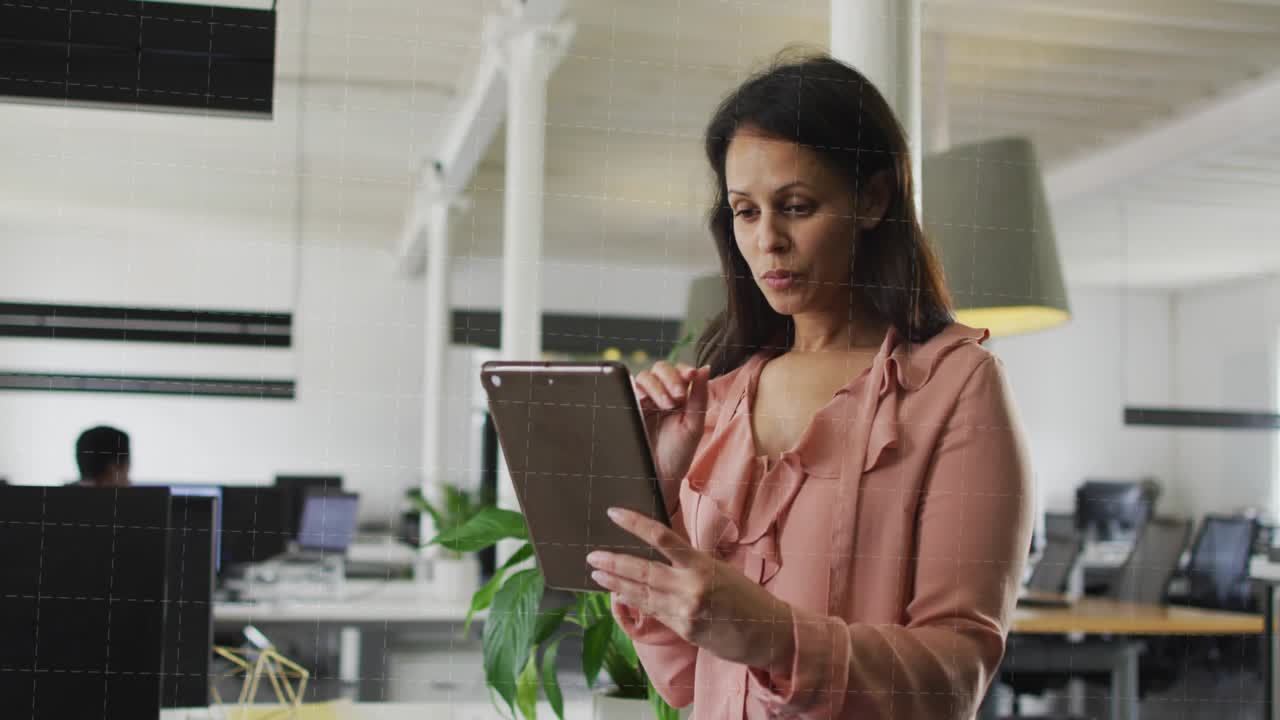 Manager tapping tablet and starting data bars flowing across business office, analyzing data