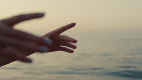 closeup girl hands raising up training yoga outdoors. woman practicing asana.