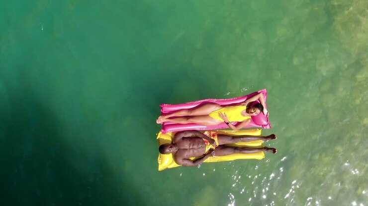 Diverse couple chilling on floats
