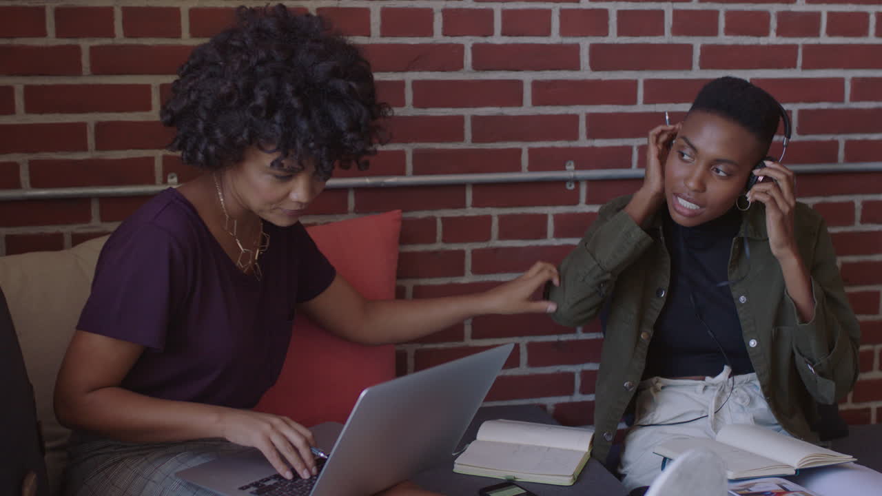 young african american business people women students study together working on creative project brainstorming sharing ideas in trendy office