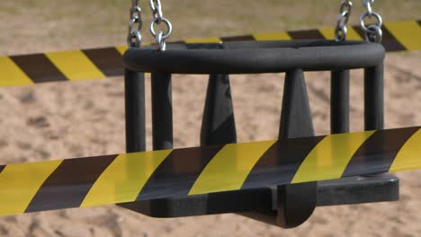 the playground is closed, close-up, swing moves