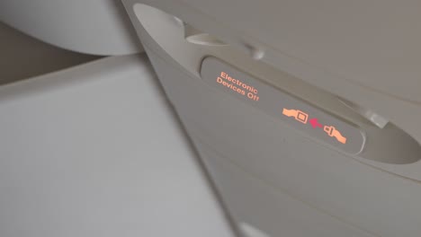 airplane overhead electronic devices off and fasten seatbelt sign