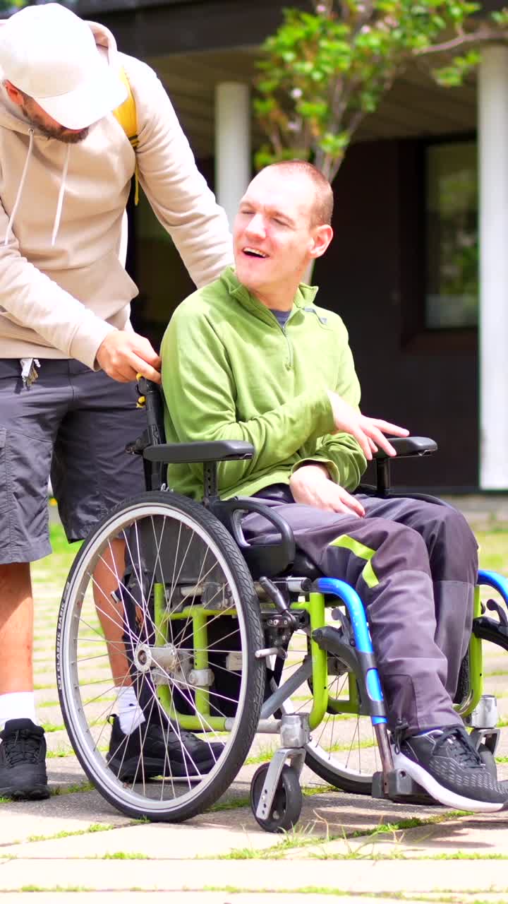 Man being pushed in a wheelchair outdoors