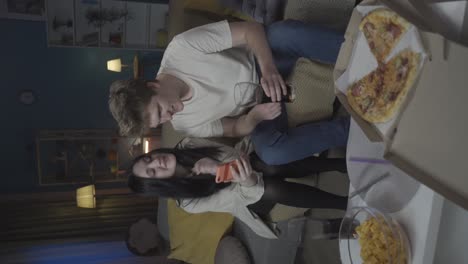 friends enjoying pizza and soda at home
