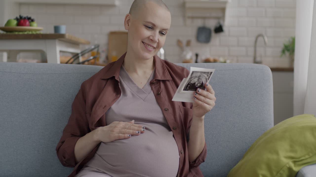 Pregnant woman looking at ultrasound photo
