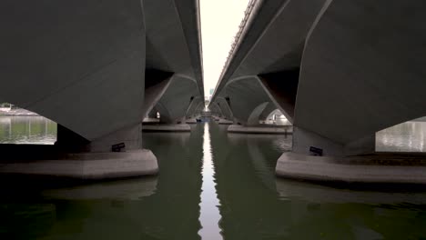 leading lines towards a small boat under the bridge