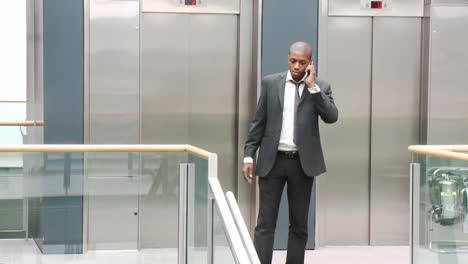 afroamerican businessman on phone in a building