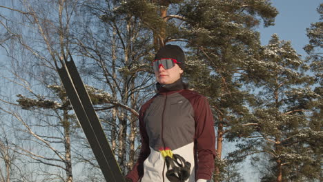 woman cross-country skiing in winter forest