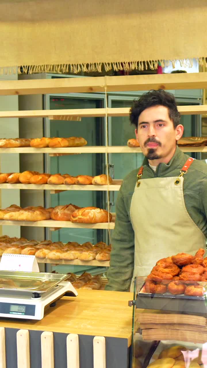 Baker serving customer in a bakery