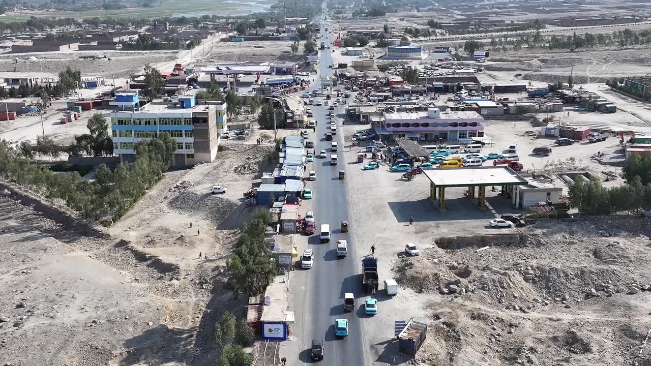 Rural Drone Aerial View of Village road Street Traffic with old school traditional tuktuks or rickshaws, Nangarhar, Afghanistan. Building Reconstruction after war