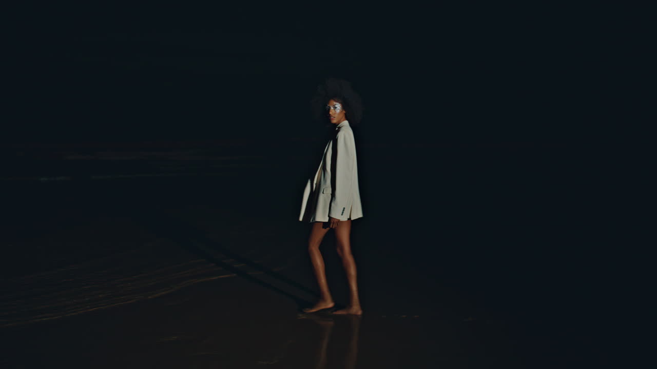 Sexy girl walking sand shore at night. Seductive   spinning beach