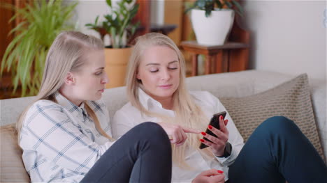 Two-Young-Womans-Doing-Online-Shopping-On-Smartphone-Browsing-Internet-Social-Media-2