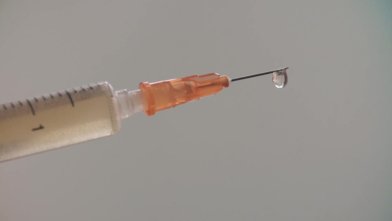 Close-up of Syringe Needle with Medicine Dropping