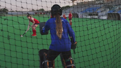 Female-hockey-players-playing-on-the-field