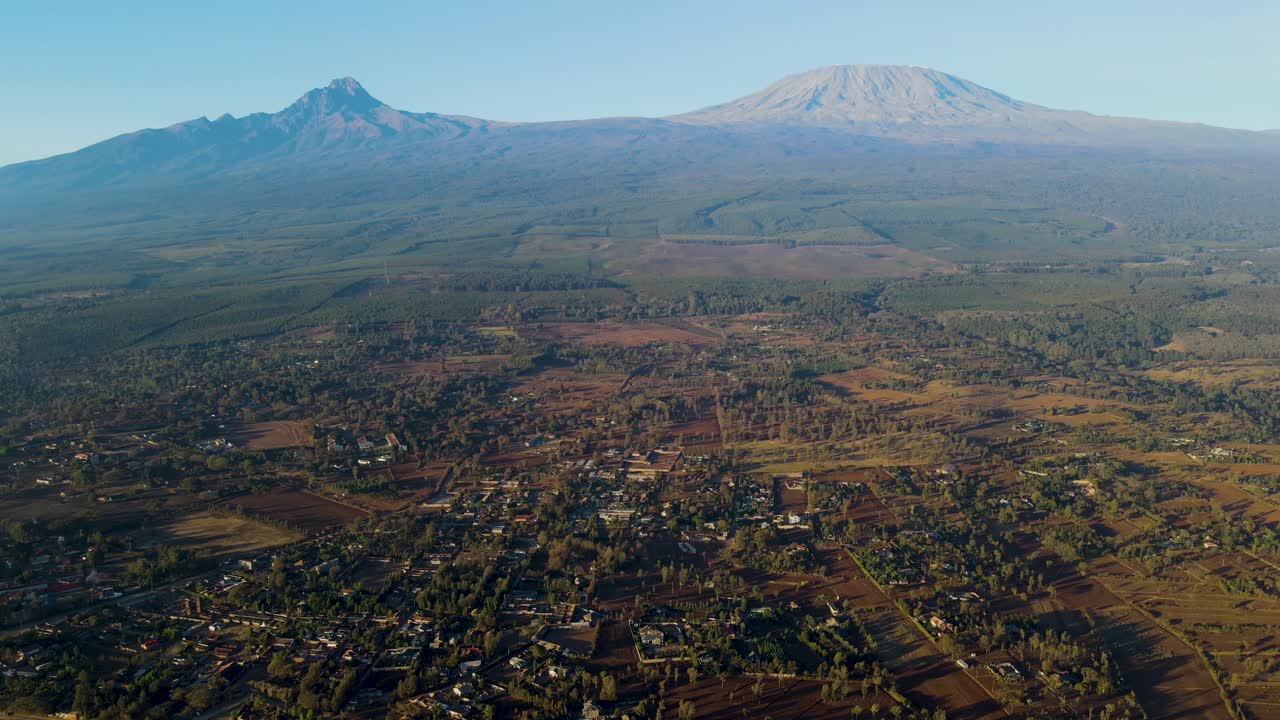 Solopgang over kenyansk landskab med landsby, Kilimanjaro og Amboseli Nationalpark – sporingsoptagelse fra drone.
