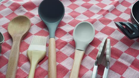 kitchen utensils on checkered tablecloth