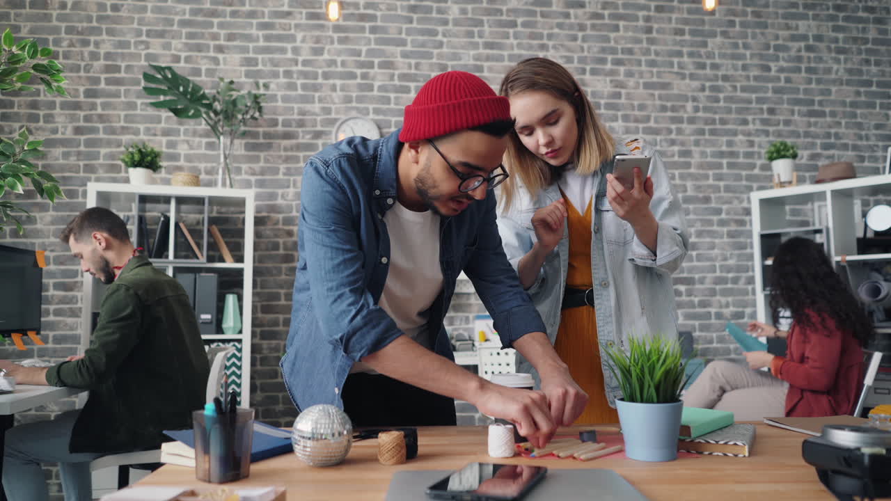 Coworkers Collaborating on Smartphone in Modern Office