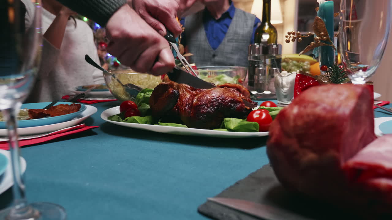 Adult man using knife to cut chicken for family