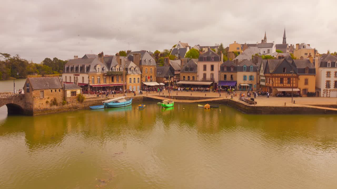 view of Saint-Goustan, Auray, Brittany, showcasing the famous half-timbered port square and the elegant Belle Époque villas along the river's embankment